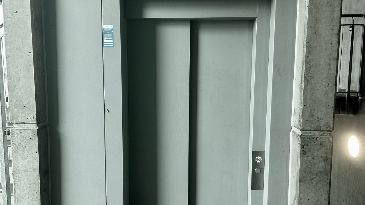 Technician repairing elevator control panel for reliable operation